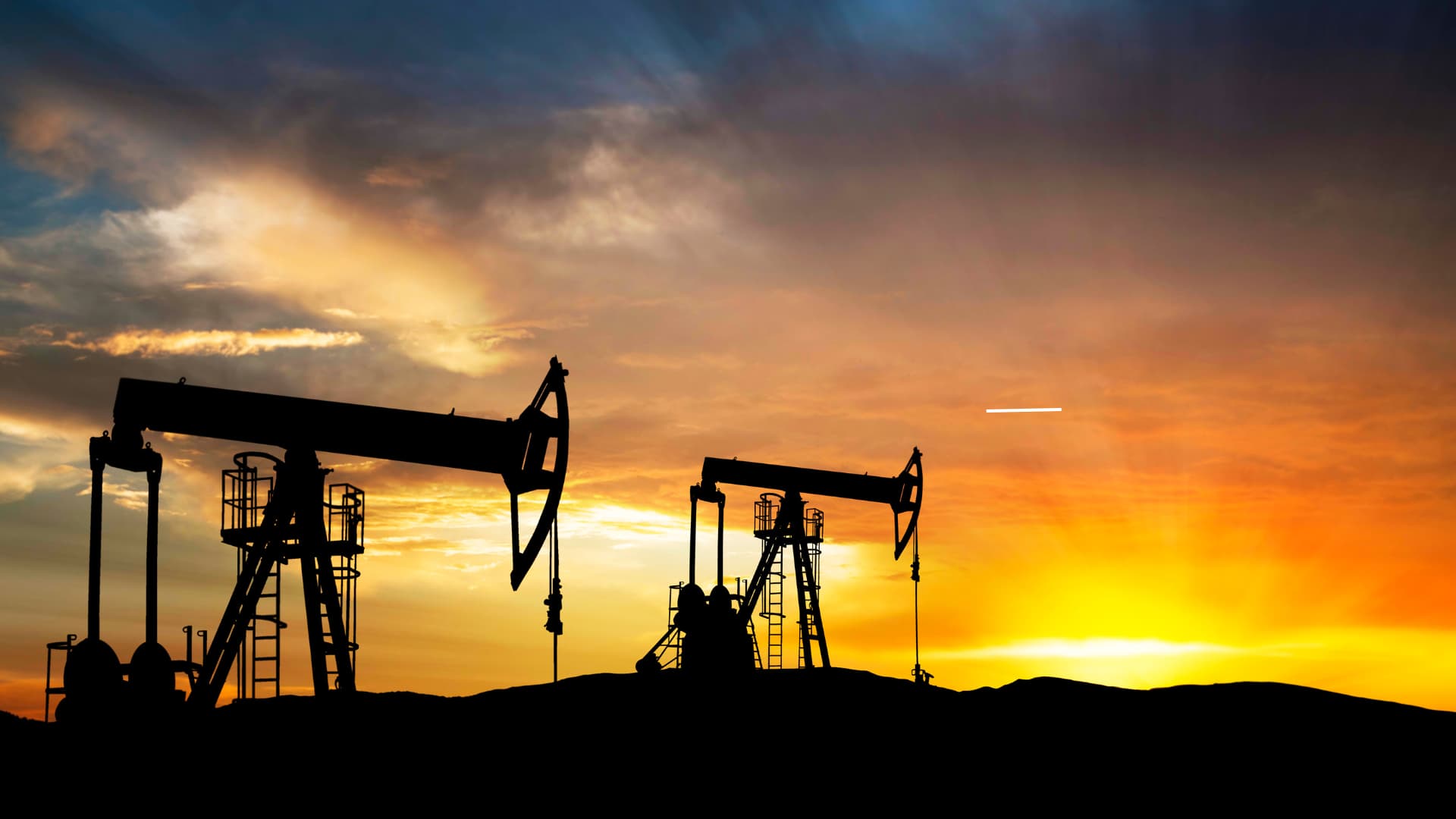 Oil and gas facility with surveillance cameras monitoring operations and perimeter